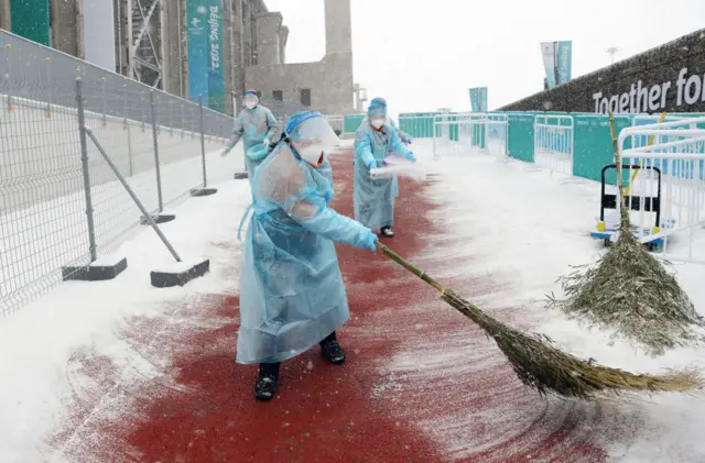 Someone sweeping snow