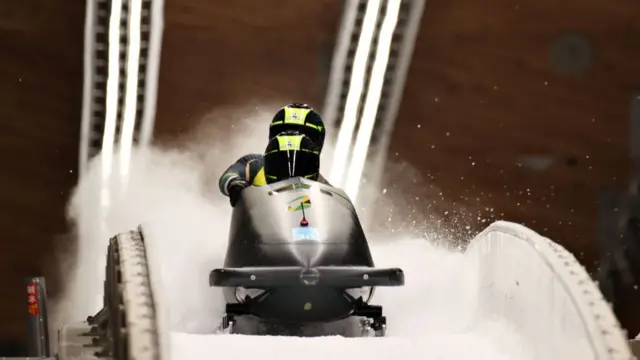 Jamaican bobsleigh team at the end of their run on track