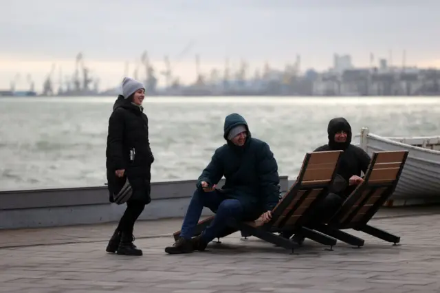 People spend time at the coast of Mariupol in Ukraine