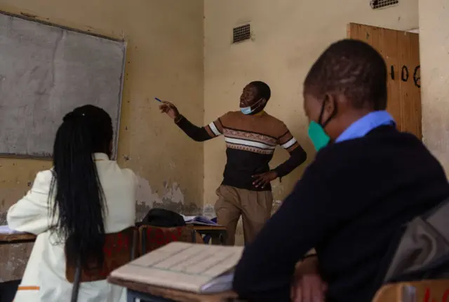 A teacher and pupils in a classroom in Harare, Zimbabwe.