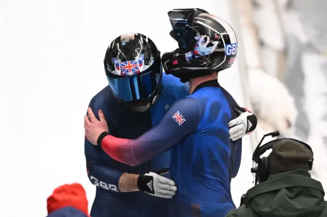 Brad Hall and nick gleeson hug