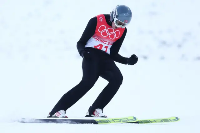 Jarl Magnus Riiber celebrates after his ski jump