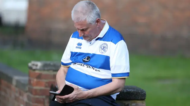 QPR fan on phone