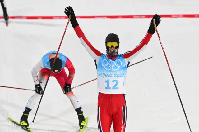 Joergen Graabak celebrates crossing the line