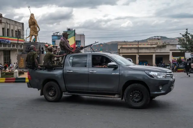 Members of the Amhara militia ride in the back of a pick up truck in the city of Gondar, Ethiopia, on January 17, 2022,