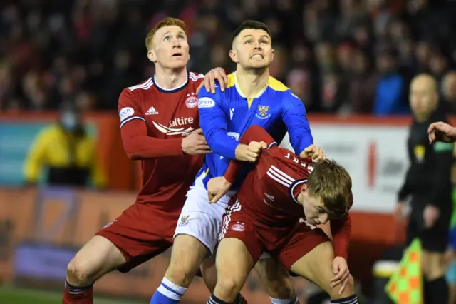 Aberdeen's David Bates (left) and Adam Montgomery compete with St Johnstone's Glenn Middleton