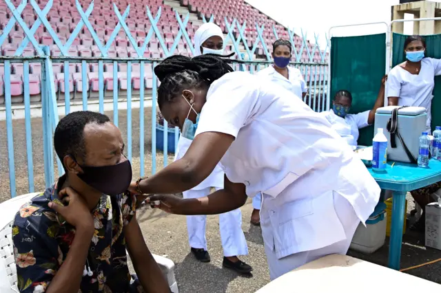 A Tanzanian medic injects a dose of the vaccine developed by US drugmaker Johnson & Johnson