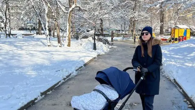 Maria with her toddler in a stroller