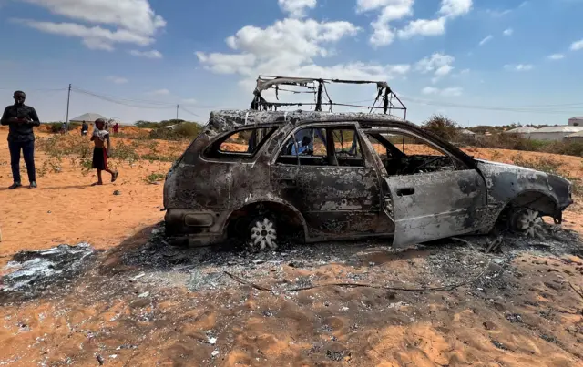 The wreckage of a car is seen burnt following an overnight attack in Mogadishu, Somalia, February 16, 2022.