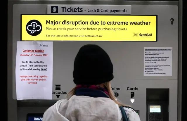 Woman at a train ticket machine