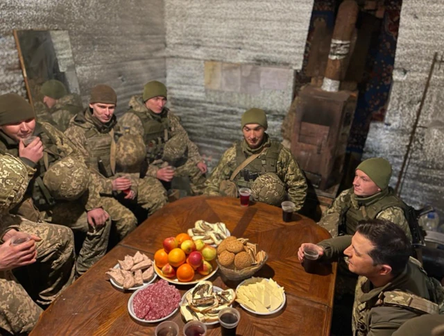 Ukrainian President Volodymyr Zelensky (bottom right) with Ukrainian soldiers in Shyrokyne