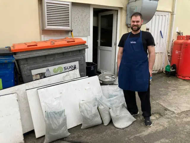 Sand bags outside cafe