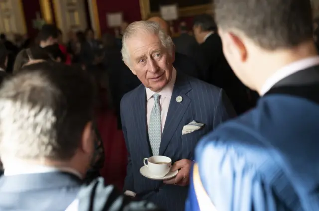 The Prince of Wales speaks to university representatives during a reception at St James's Palace, London