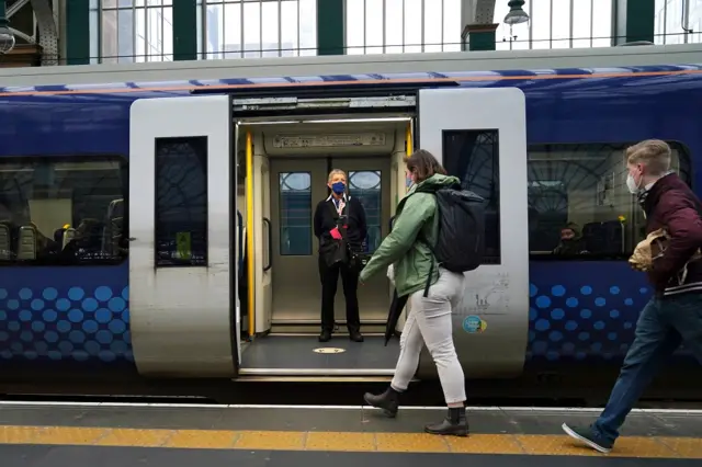 Passengers get on a train