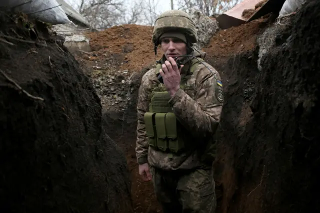 A Ukrainian soldier in a trench on the frontline