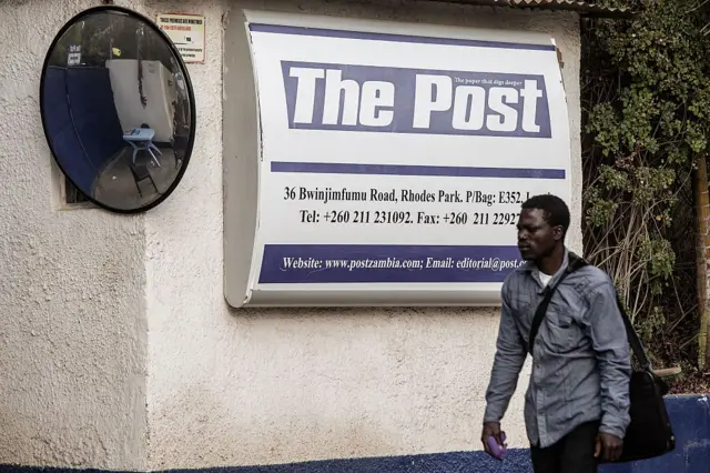 A man passes the office of the now-closed independent newspaper "The Post" on August 9, 2016 in Lusaka.