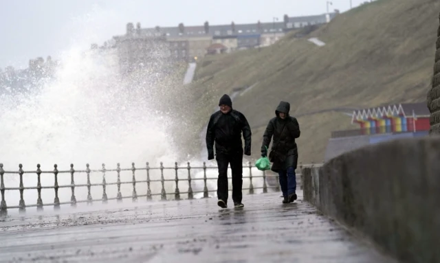 Waves hit Whitby sea wall