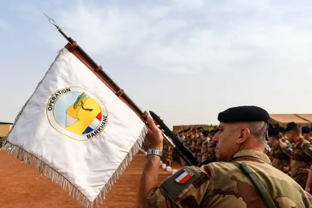 A French soldier stand to attention during a visit by the French Prime Minister to Operation Barkane's military French base in Gao, Mali, in 2019.