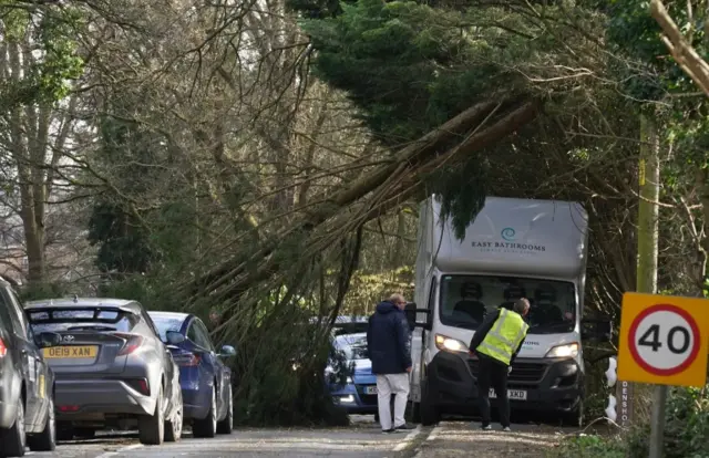 A fallen tree blocks a road in Eynsham in Oxfordshire due to Storm Eunice