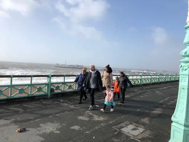 People walk along Worthing and Brighton seafronts