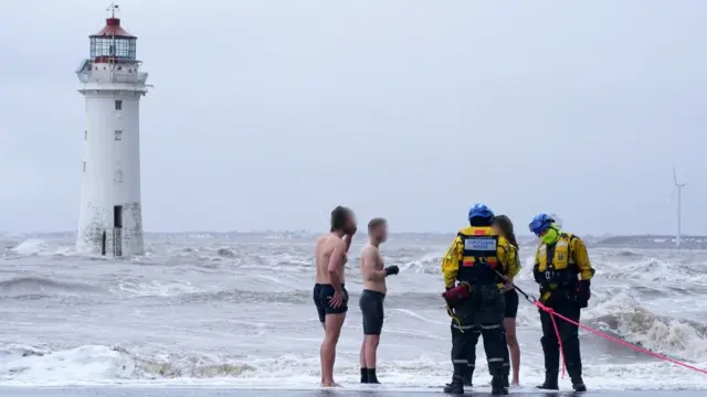 Swimmers being told to leave the sea by the coastguard