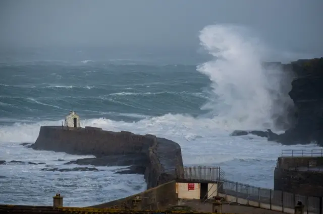 Waves crash into rocks on the coastline of Newquay