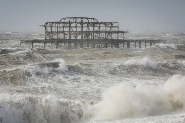 The skeleton of Brighton's West Pier surrounded by crashing, frothy waves