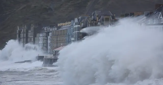 Waves causedbreak over Aberystwyth promenade