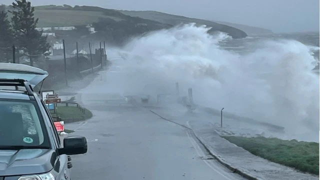 The coastal road in Amroth, Pembrokeshire, was hammered by waves