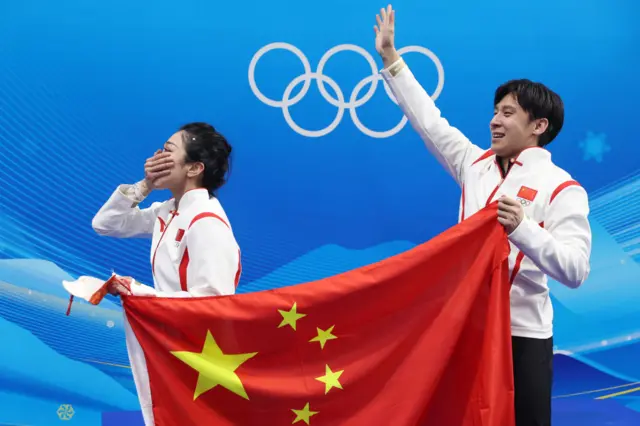 China figure skating pair emotional with flag