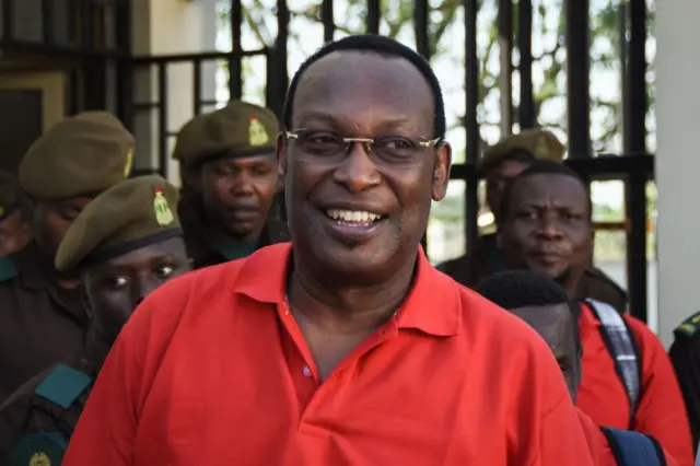 Tanzania's main opposition Chadema party chairman Freeman Mbowe (R, in red) who was arrested on July 21, 2021, leaves the High Court in Dar es Salaam, Tanzania, on 18 February.