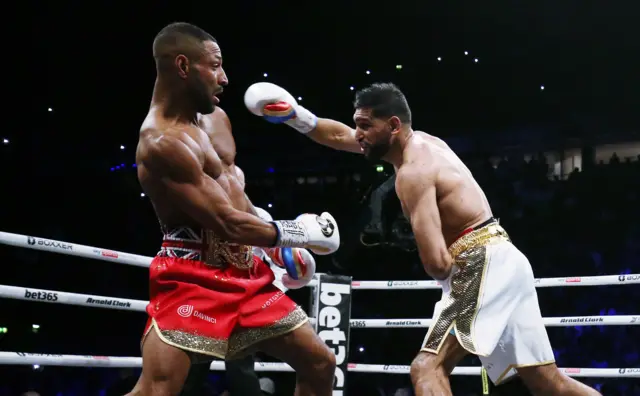 Amir Khan punches Kell Brook