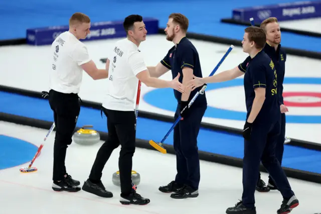 GB and Sweden shake hands after final