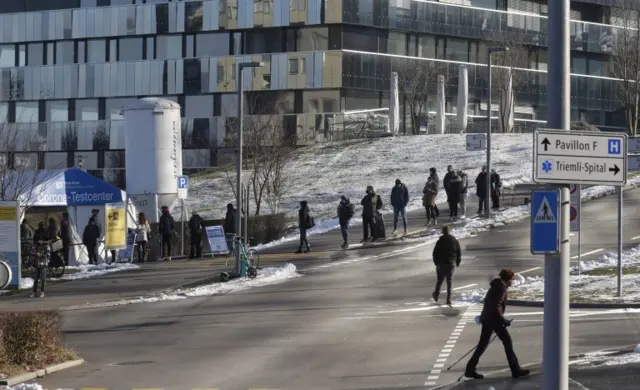 People queue at a test centre at the Stadtspital Triemli hospital in Zurich, Switzerland, on 13 January 2022
