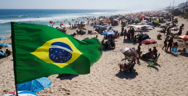 n aerial view of people enjoying the weather at Barra da Tijuca beach on December 20, 2020 in Rio de Janeiro, Brazi