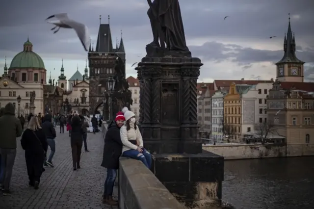 A couple embraces on Charles Bridge in Prague, Czech Republic, on 3 January 2022