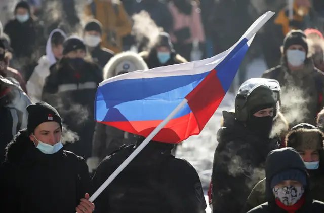 A demonstrator with a Russian flag