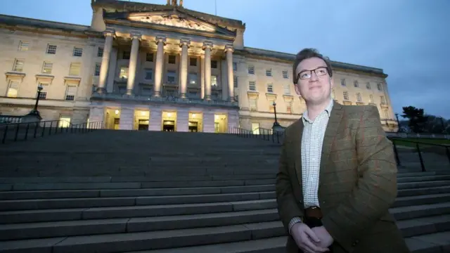 Christopher Stalford standing outside Stormont