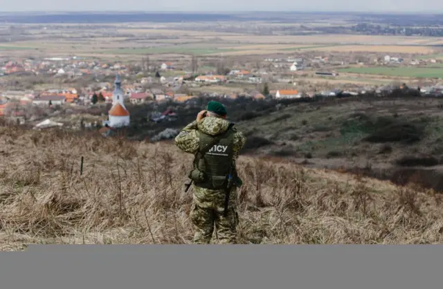 A Ukrainian guard patrols the border with Hungary last year