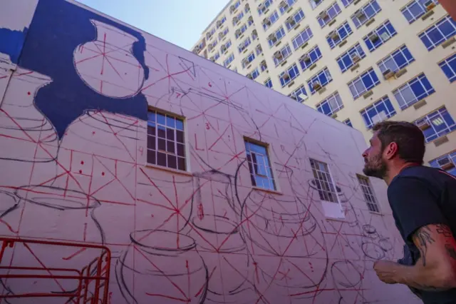 Spanish artist Manolo Mesa works on a multi-storey massive public mural ahead of the opening of the International Public Art Festival (IPAF) in Cape Town, South Africa, 22 February 2022. The 6th edition of the International Public Art Festival (IPAF) runs from 23 till 27 February 2022