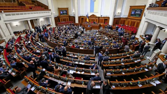 Ukrainian lawmakers attend a session of parliament in Kyiv, Ukraine