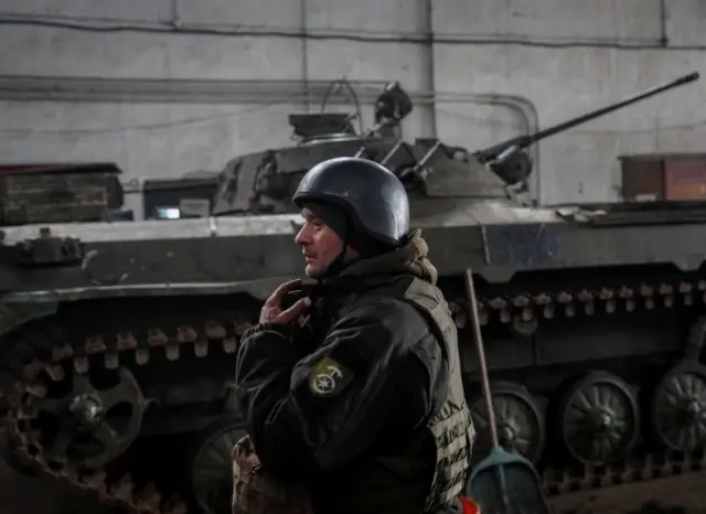 A Ukrainian soldier stands near an infantry fighting vehicle on the front line near Novoluhanske in the Donetsk region, eastern Ukraine. Photo: 22 February 2022