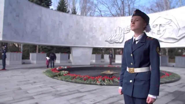 Servicewoman standing to attention