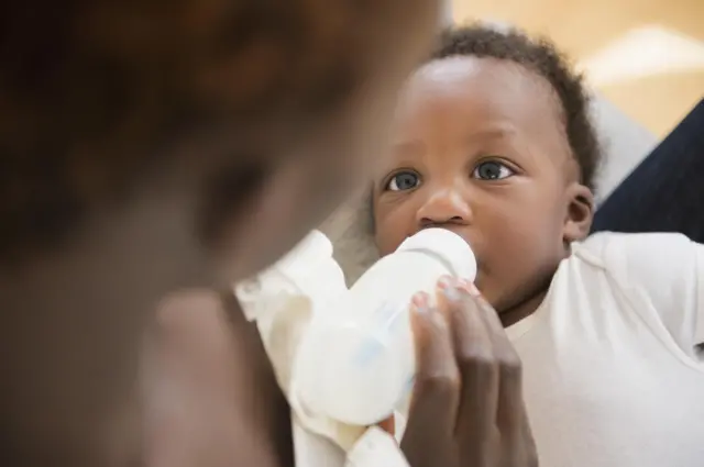 Baby drinking milk from bottle