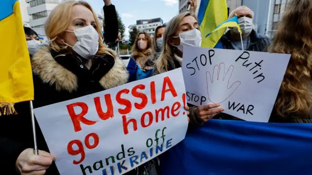 Ukrainians residing in Japan hold placards and flags during a protest rally denouncing on Russia over its actions in Ukraine, near Russian embassy in Tokyo, Japan