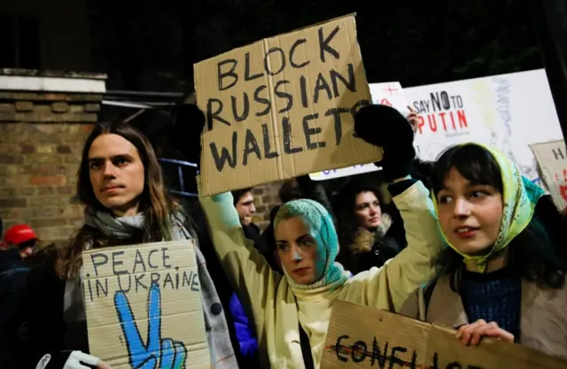 Protesters holding placard outside Russian embassy in London