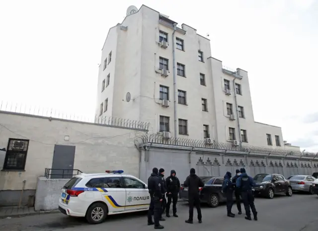 Police officers and members of the Ukrainian National Guard outside the Russian embassy in Kyiv