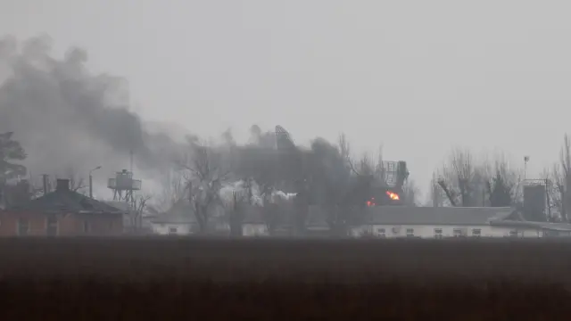 Smoke is seen coming out of a military installation near the airport in Mariupol, eastern Ukraine