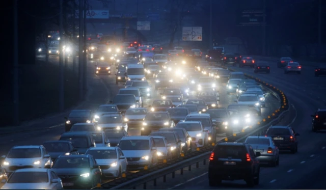 Cars queue to exit Kyiv in the early morning of Thursday