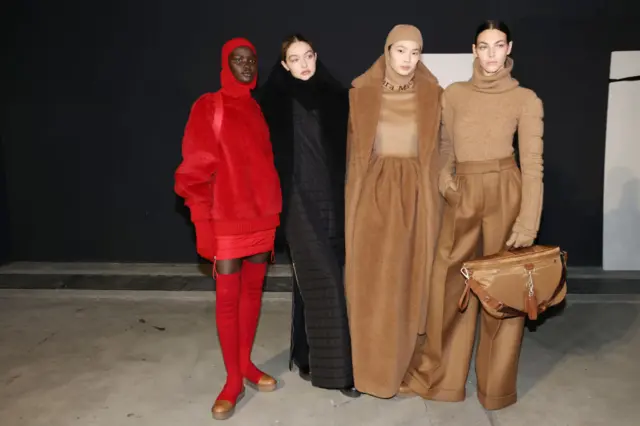 Akon Changkou, Gigi Hadid, Sherry Shi and Vittoria Ceretti pose backstage of the Max Mara fashion show during the Milan Fashion Week Fall/Winter 2022/2023 on February 24, 2022 in Milan, Italy